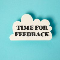 White cloud with the words time for feedback written in black. Concept of urgency and importance, as if the viewer needs to provide feedback quickly